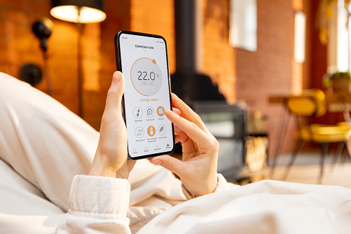 Woman holding phone with running smart home portable ac "banner"