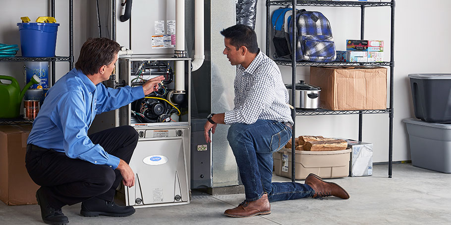 carrier furnace with technicians explaining 